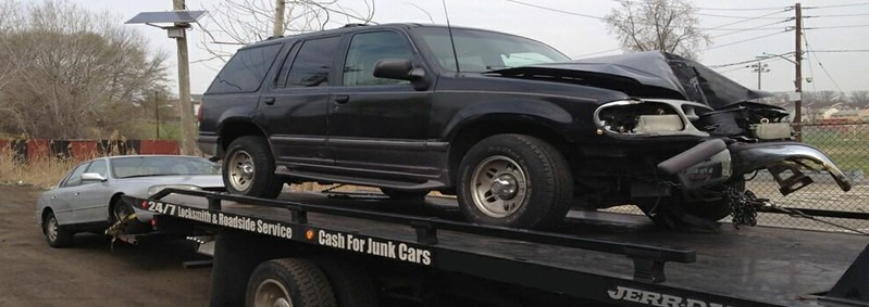 A damaged car being transported to junk car service