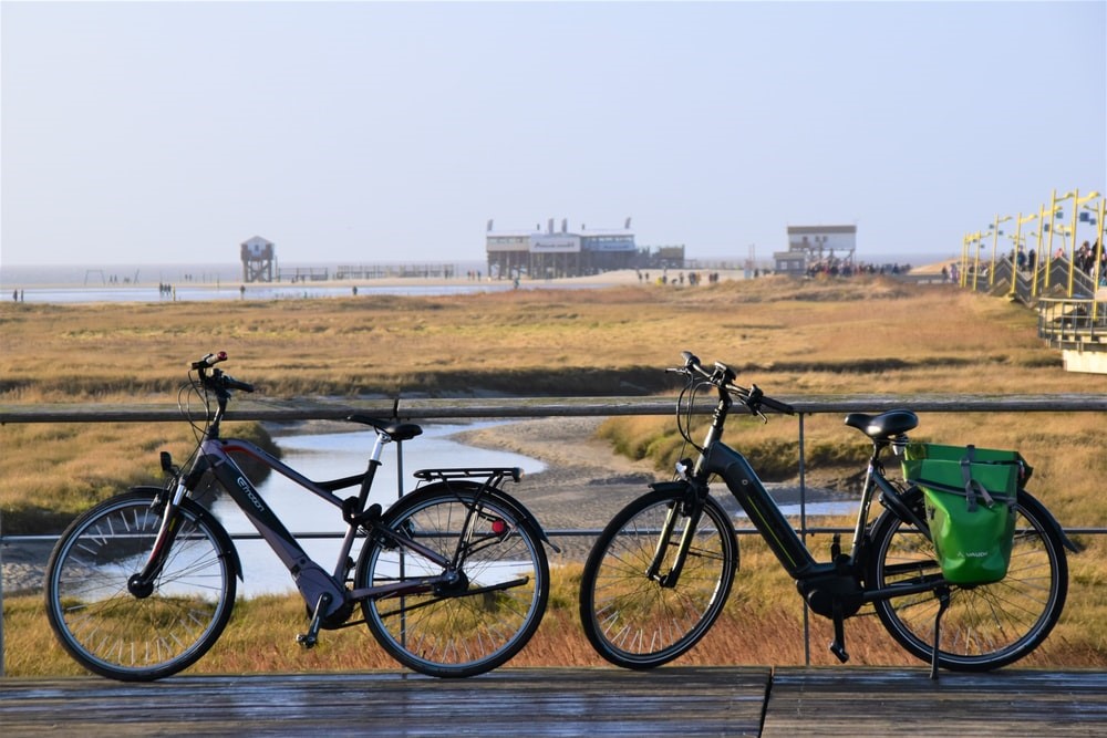 Two bicycles parked on the side of a road