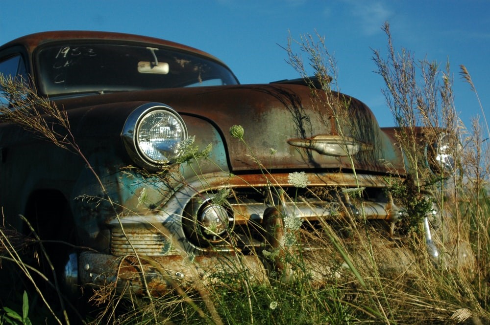 old, rusty car in the wild