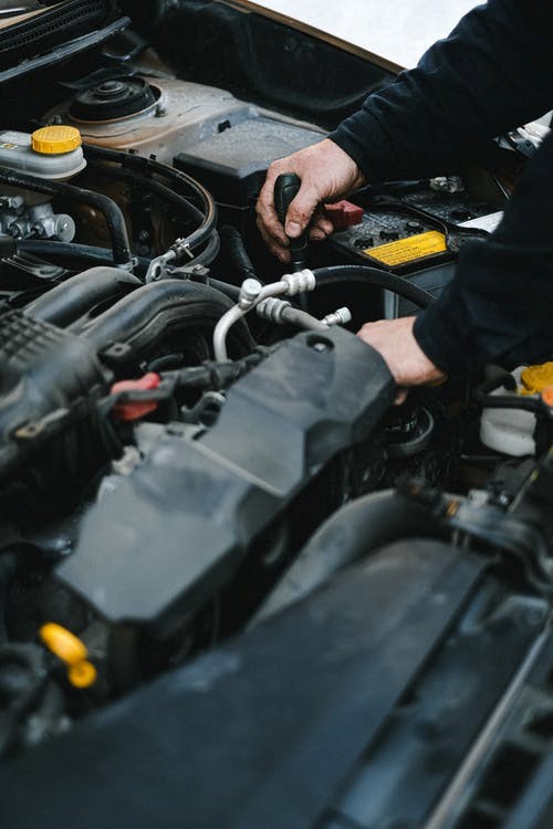 mechanic fixing a car engine