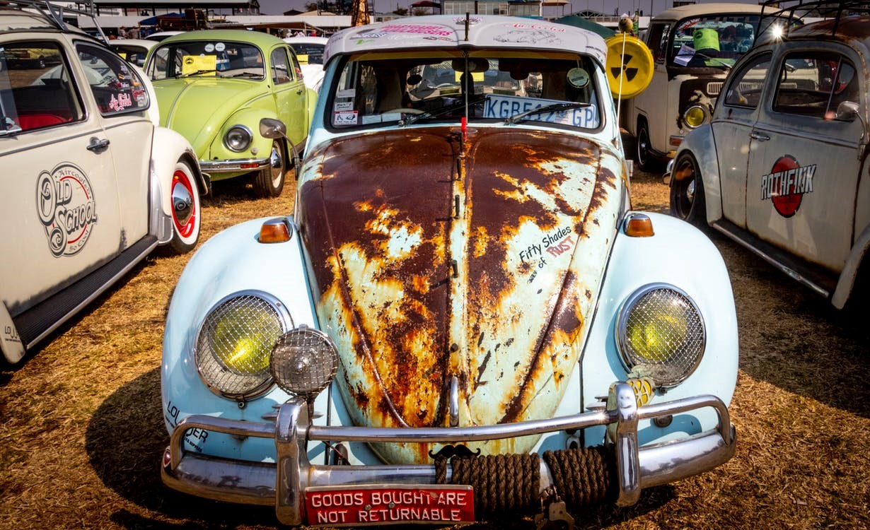 A rusty car in a junkyard