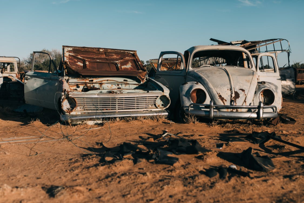 Rusty and damaged retro cars at a junkyard