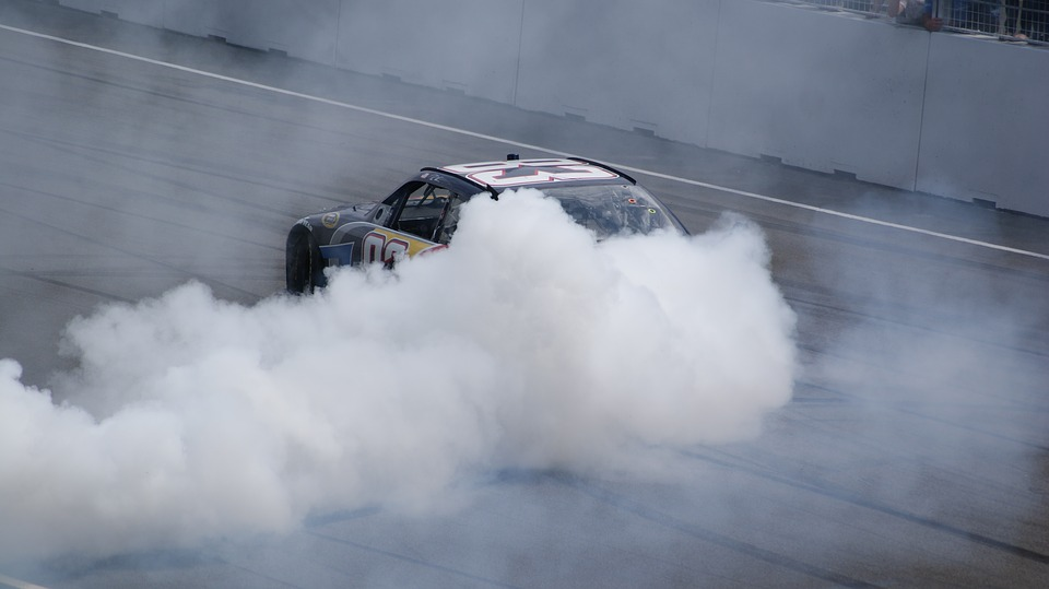 A car is releasing excess exhaust smoke