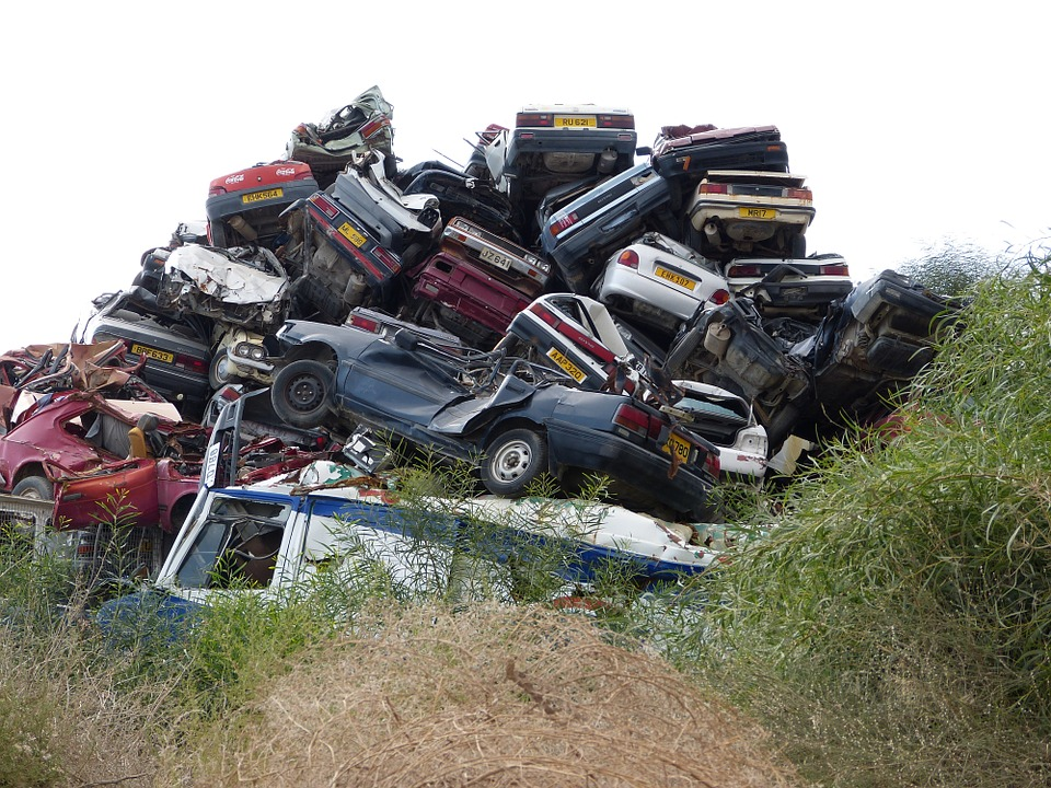 Damaged cars piled up on top of each other 