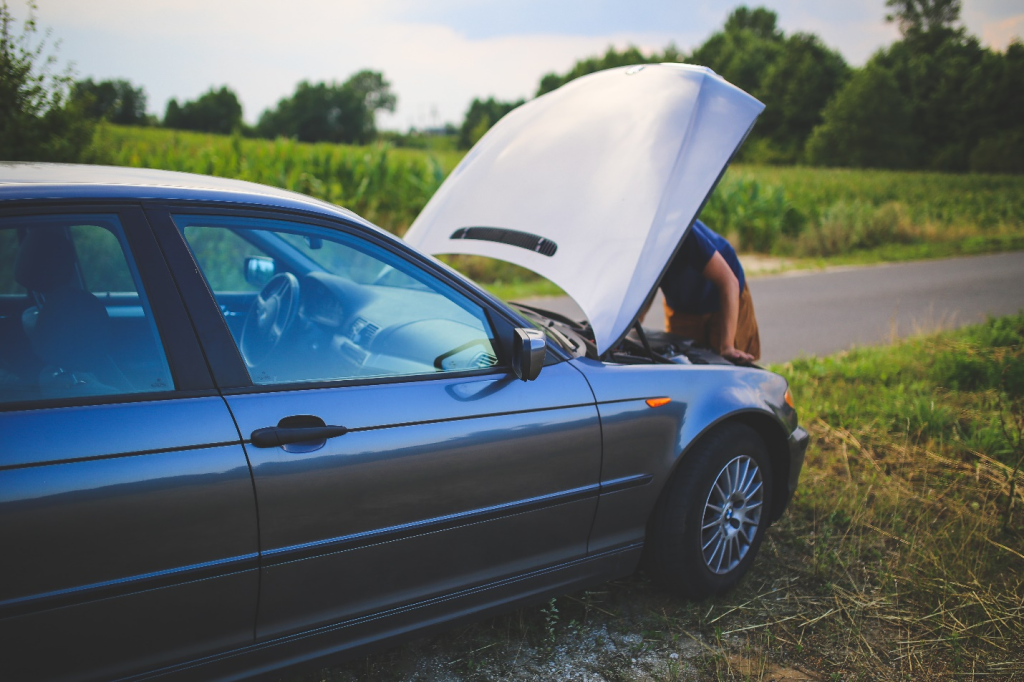 a person fixing an old car