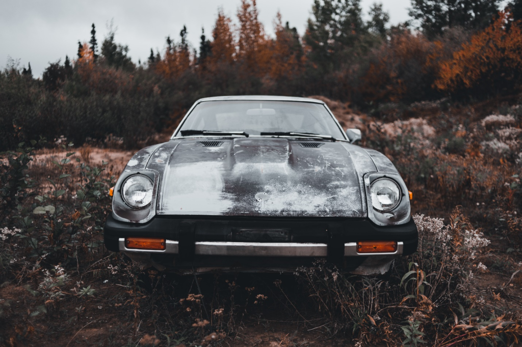 an old car parked in a field