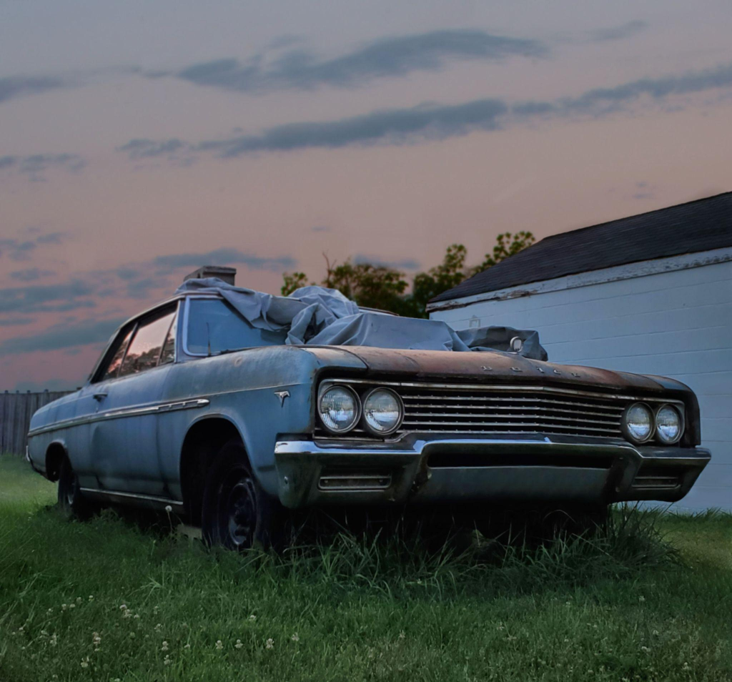 A blue junk car smashed from the windshield