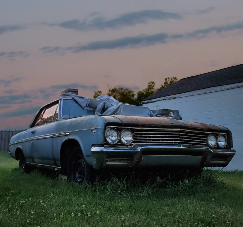 A junk car parked out of a house