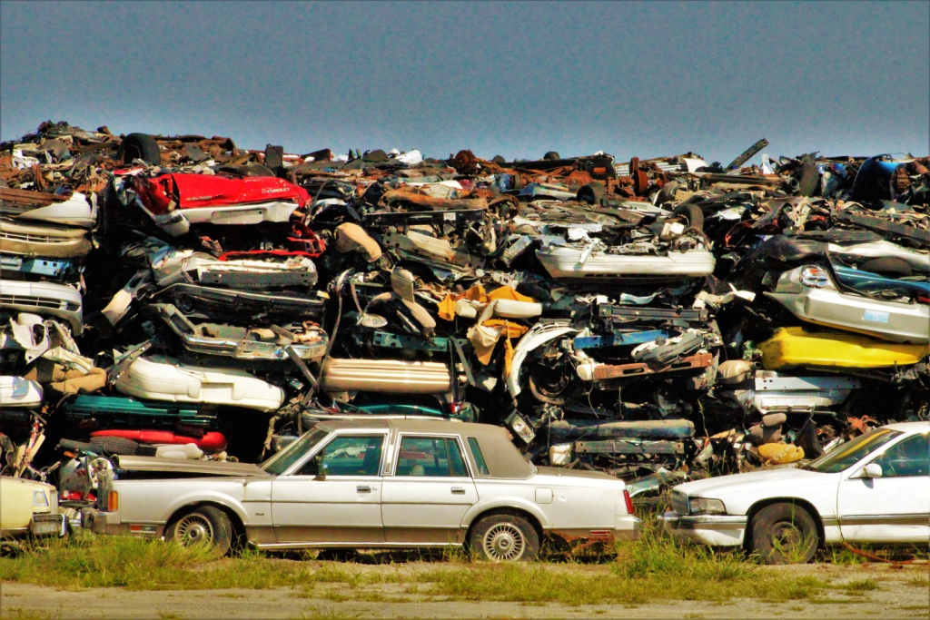 Junk cars dumped on a grass field