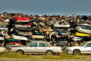 Junk cars dumped on a grass field