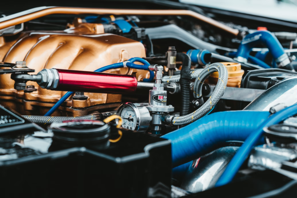 A photo showing a car engine with copper-colored components.