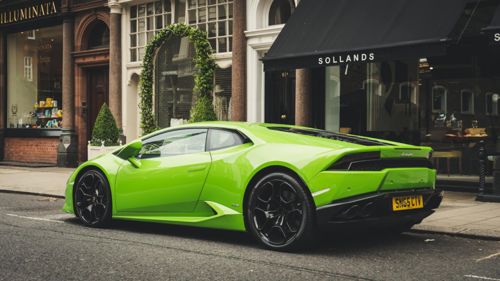 A photo showing a green supercar parked on a street.