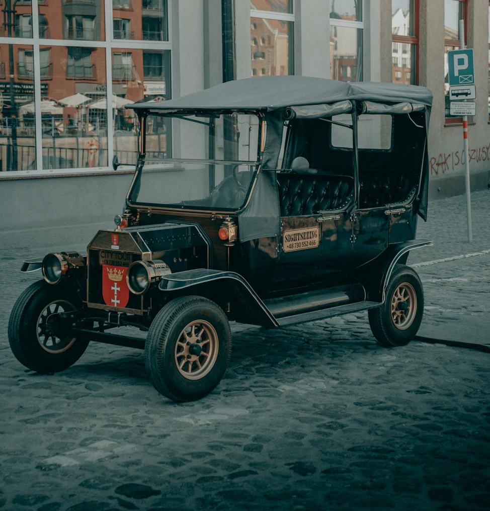 A photo showing a vintage car on a street.