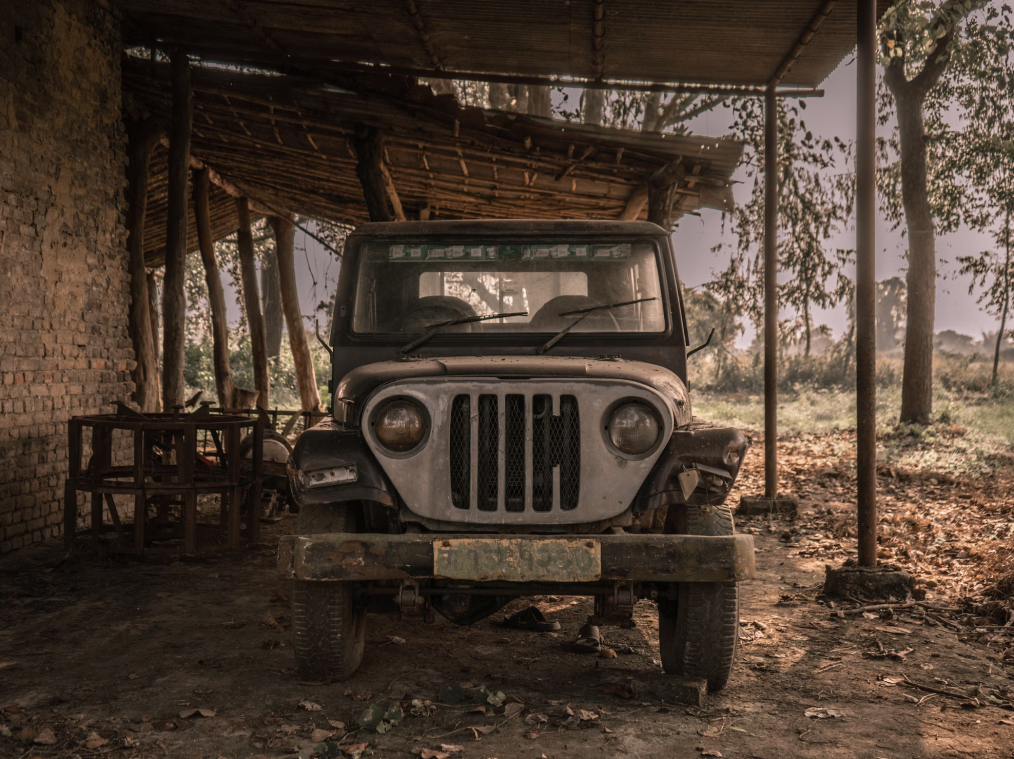 A photo showing an old jeep parked outdoors.