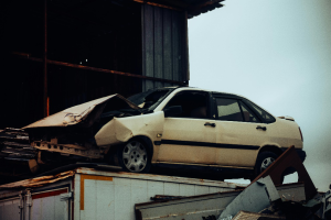 An old accidented car with a bashed in bonnet