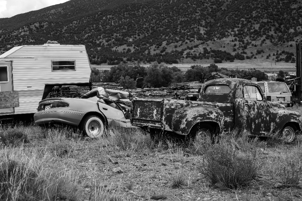 A black and white shot of a salvage yard 