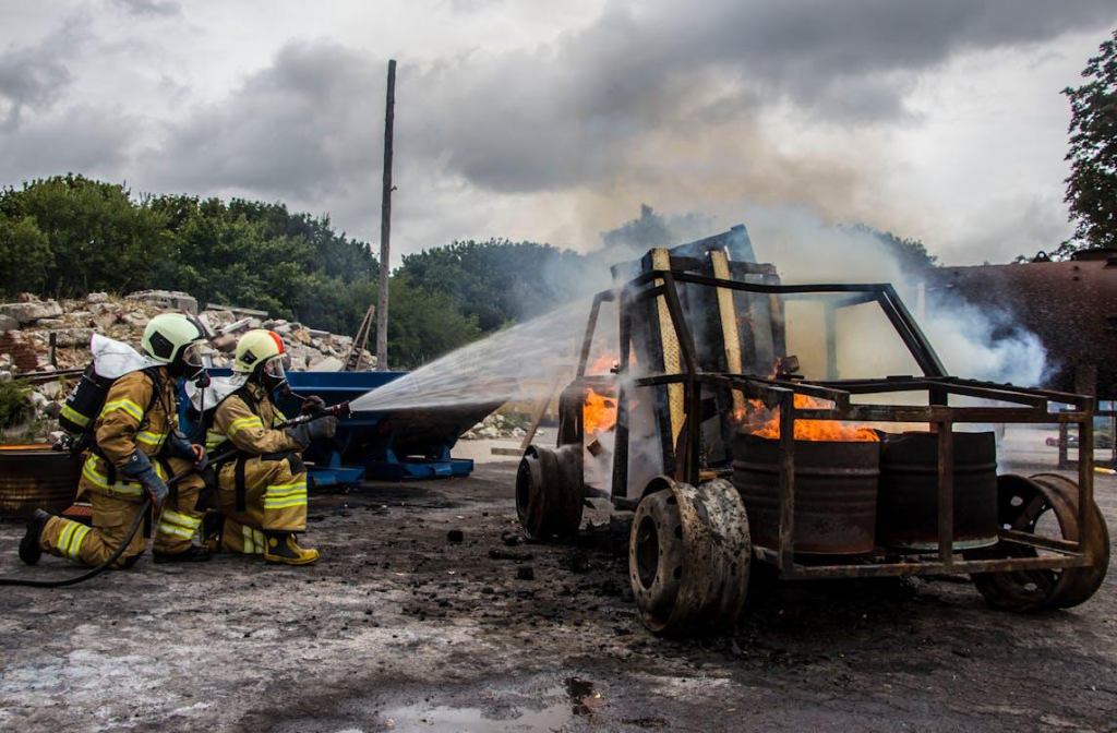 Firefighters extinguishing a car.