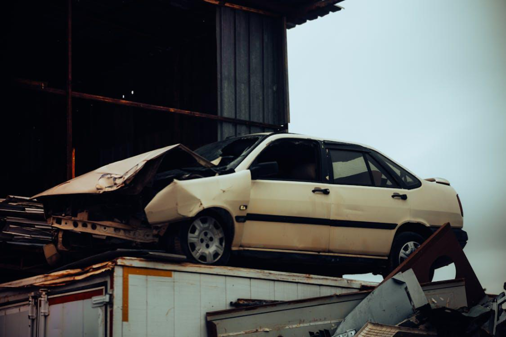 A junk car ready to be sold for cash at a scrapyard.