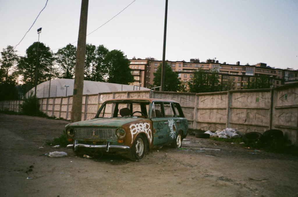 A vintage station wagon parked near a line post.