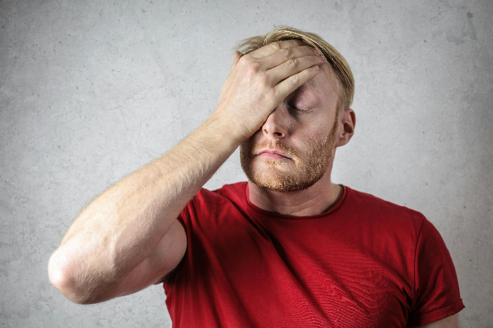 Man in a red t-shirt worried about engine failure