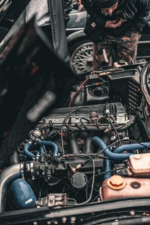 Man inspecting a car engine
