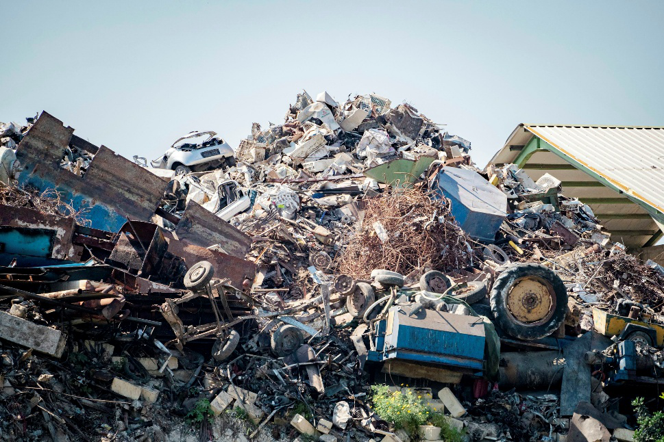 Large pile of scrap metal and junk cars at a scrapyard