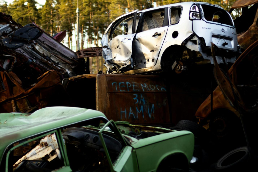 Congested view of junk cars piled on top of each other.