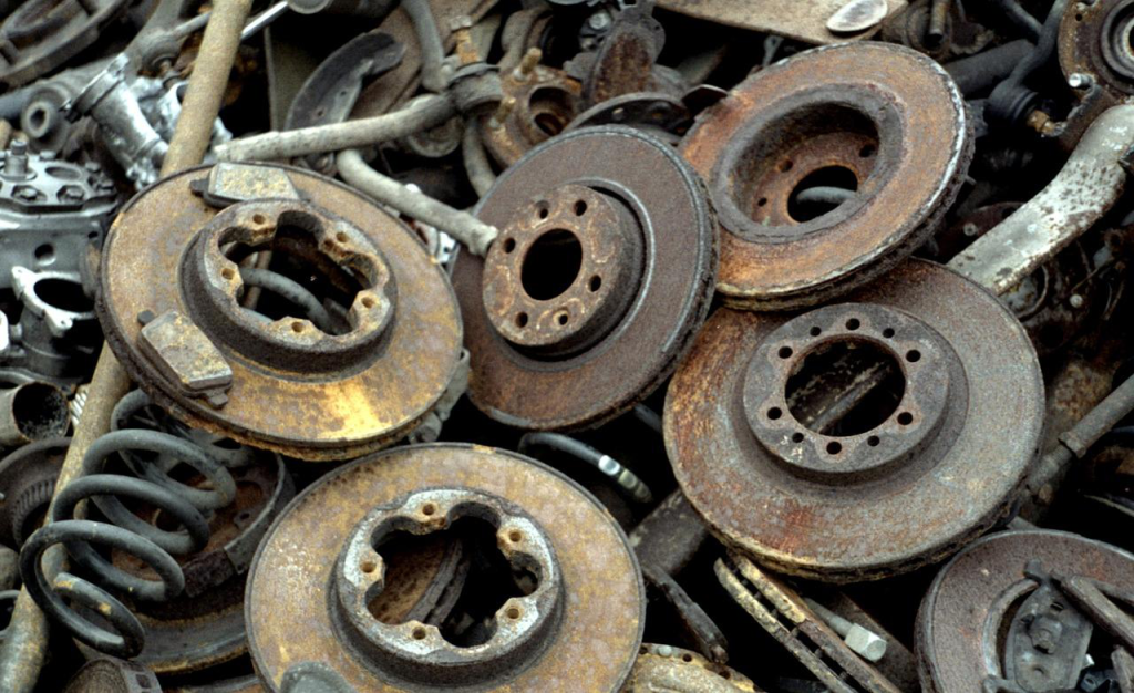 Close up of stacked and rusted car parts.